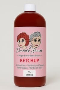 1L bottle of 2 Donna’s Sauces Sugar Free Ketchup featuring a pink label with two illustrated women.